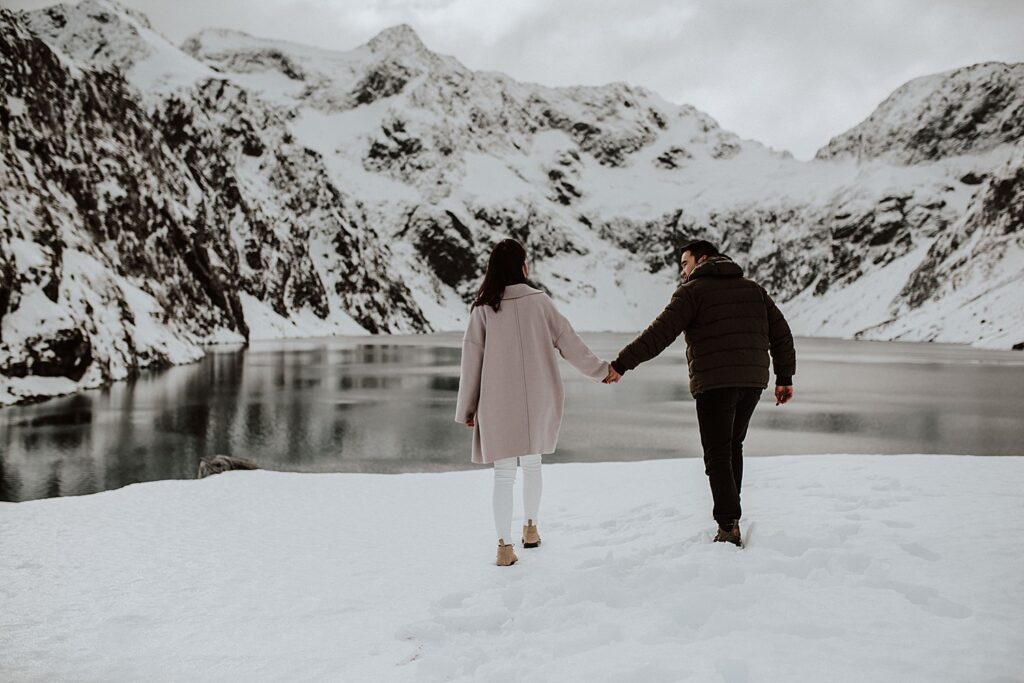 Couple standing holding hands at Lake Erskin Queenstown Elopements