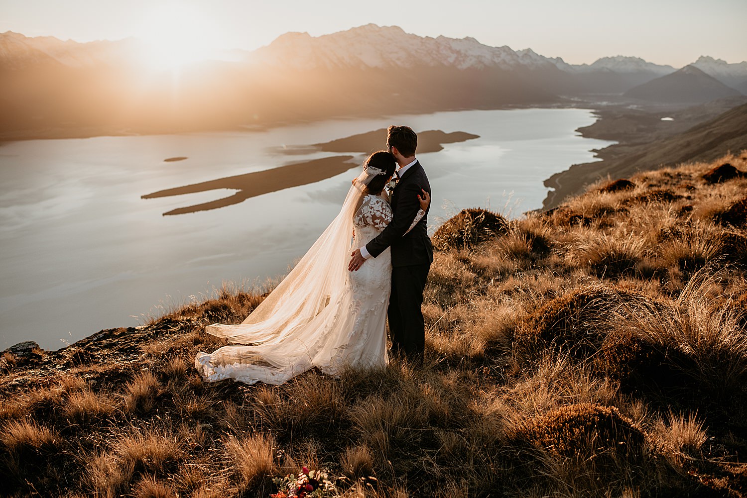 Couple standing on the hills in wedding outfit at Mt Crichton, Queenstown Elopements 