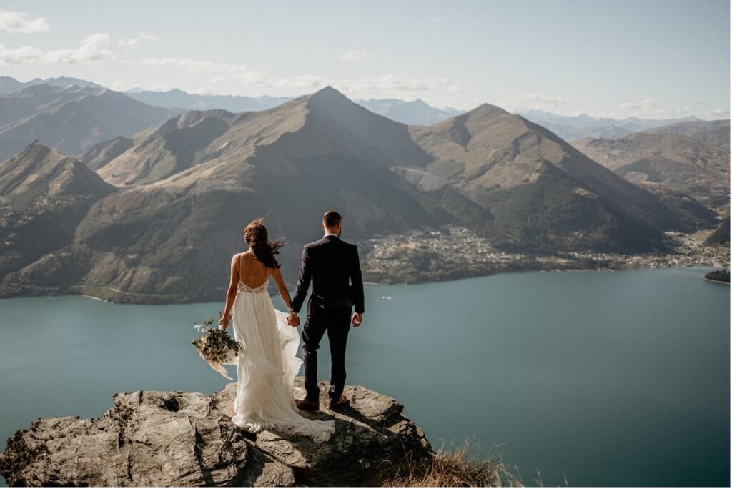 Summer Elopement in Queenstown, Couple looking over the lakes out towards the mountain - Queenstown Elopements 