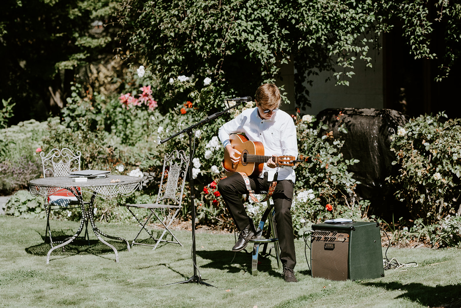 Elopement Packages Queenstown- Boy playing a song on the guitar at a wedding  